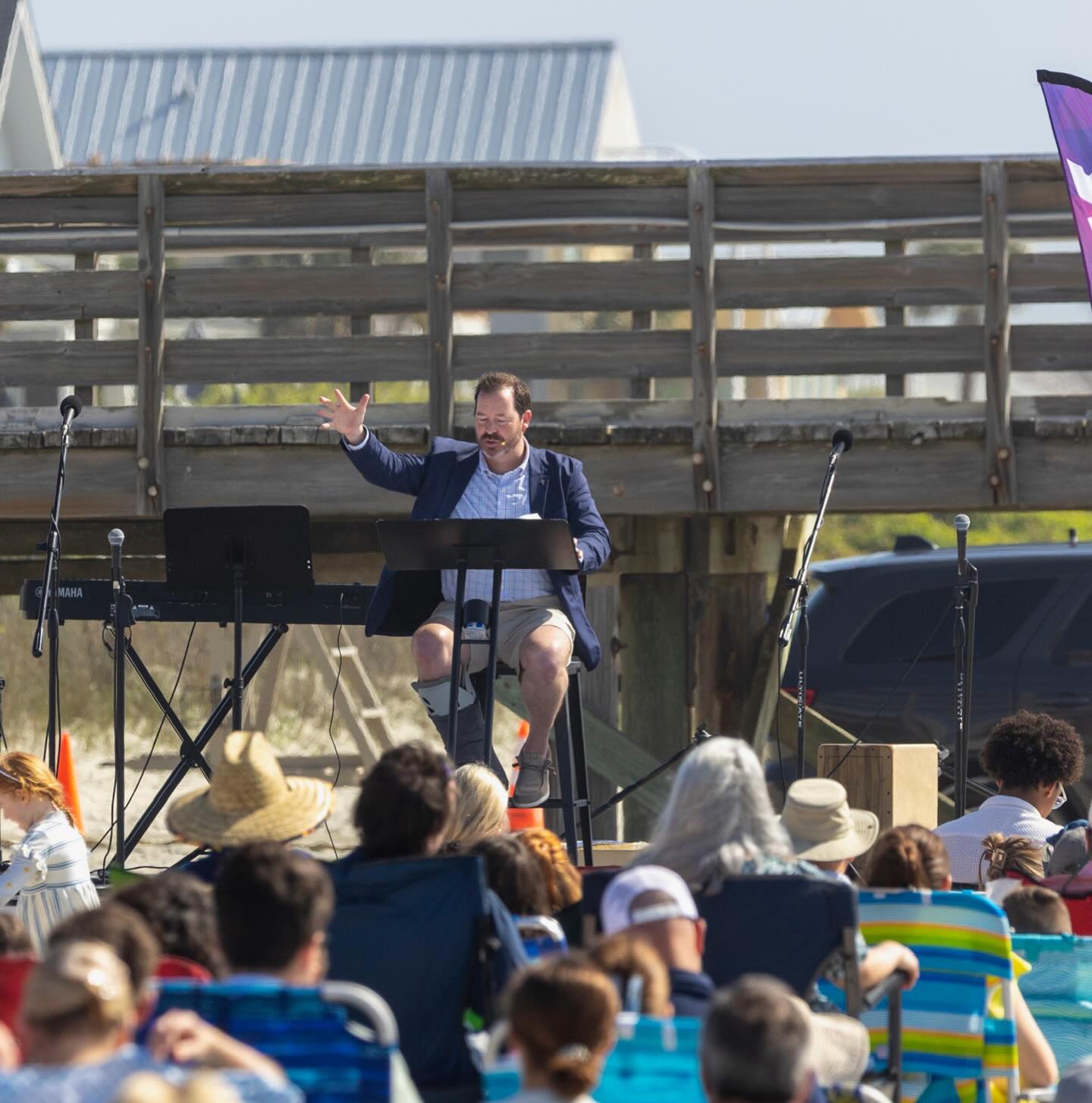 Pastor teaching from the beach stage